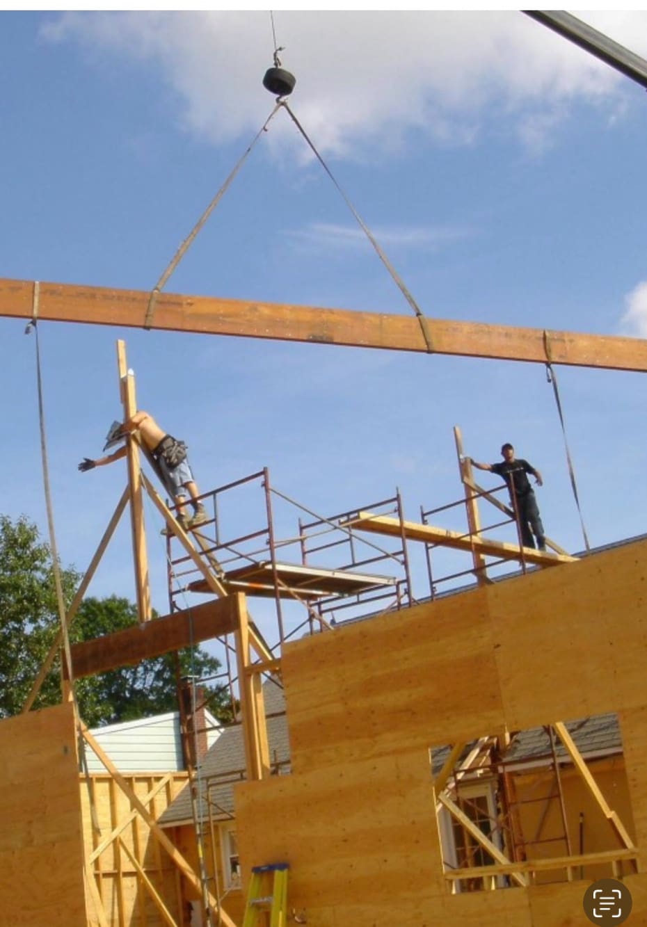 Two men working on a wooden structure.